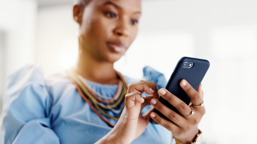 Hands, phone and typing with contact at office with space, texting and notification at real estate agency. Woman, realtor or property developer with smartphone, mobile app and web chat at workplace
