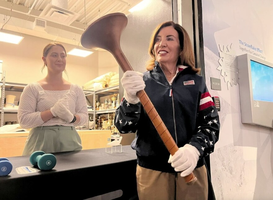 Gov. Kathy Hochul holding the Olympic torch from the 1980 Winter Games in Lake Placid.