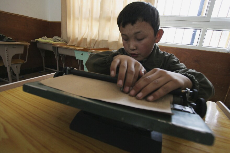 A blind child studies at the Braille Without Borders school  in Lhasa, Tibet, in 2005. The program was the first of its kind in the country.