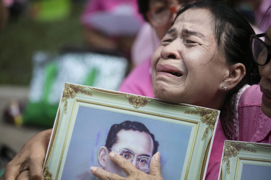 A Thai woman cries as she prays for Thailand's King Bhumibol Adulyadej on Thursday outside Siriraj Hospital, where he was being treated, in Bangkok.