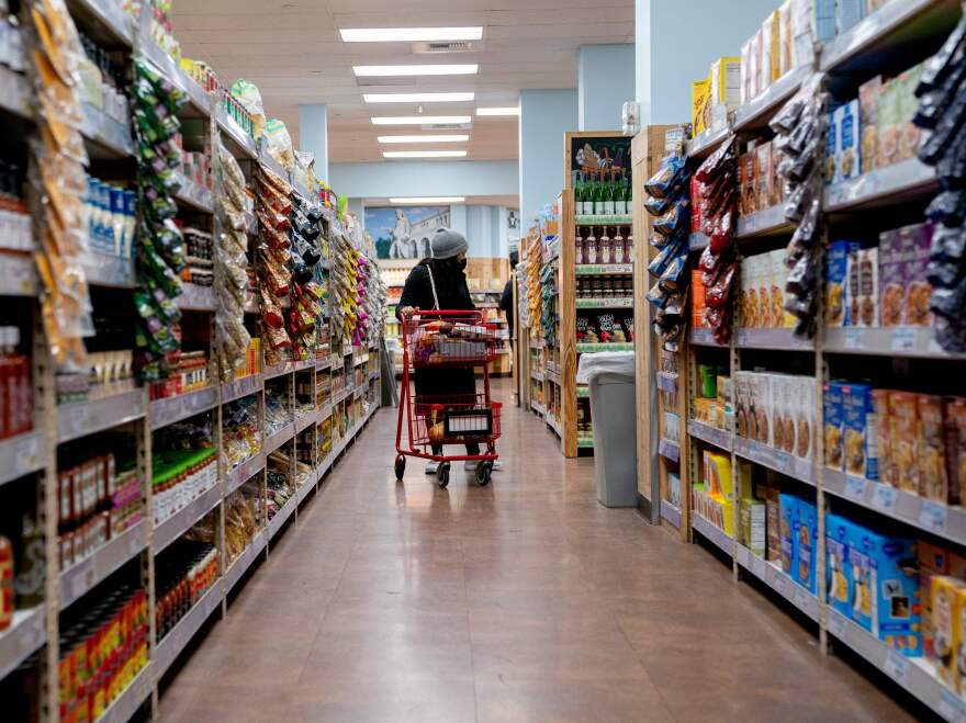 A shopper walks through a grocery store in Washington, D.C, on March 13. Surging inflation poses a particular challenge for working-class families, impacting the cost of basic necessities such as groceries.