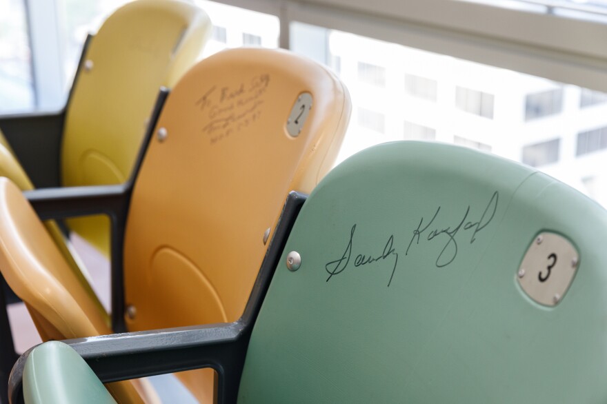 A row of autographed chairs from Dodger Stadium sits in Selig's office. The signatures include long-time manager Tommy Lasorda, Hall-of-Fame pitcher Sandy Koufax, broadcaster Vin Scully.