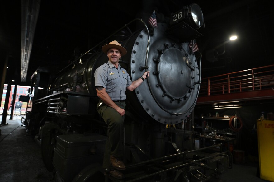 Steamtown National Historic Site new superintendent, Jeremy Komasz, stands on steam engine 26 at the national park in Scranton.