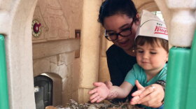 With help from his nanny, Poulleth Jimenez, 2-year-old Jack Helton runs a donut shop out of his plastic green and beige playhouse.