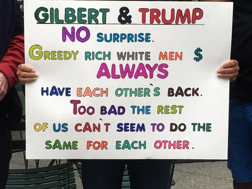 One of the signs at the anti-Gilbert protest in downtown Detroit Monday.