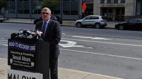 Robert Hoatson of Road to Recovery stands along Main Street in Buffalo Friday morning, across from the Catholic Diocese of Buffalo's headquarters. Hoatson renewed his frequent calls for Bishop Richard Malone's resignation while stating that a similar call to the bishop by the Movement to Restore Trust is "a major move." Credit Michael Mroziak, WBFO