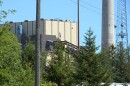 A large building next to a smoke stack