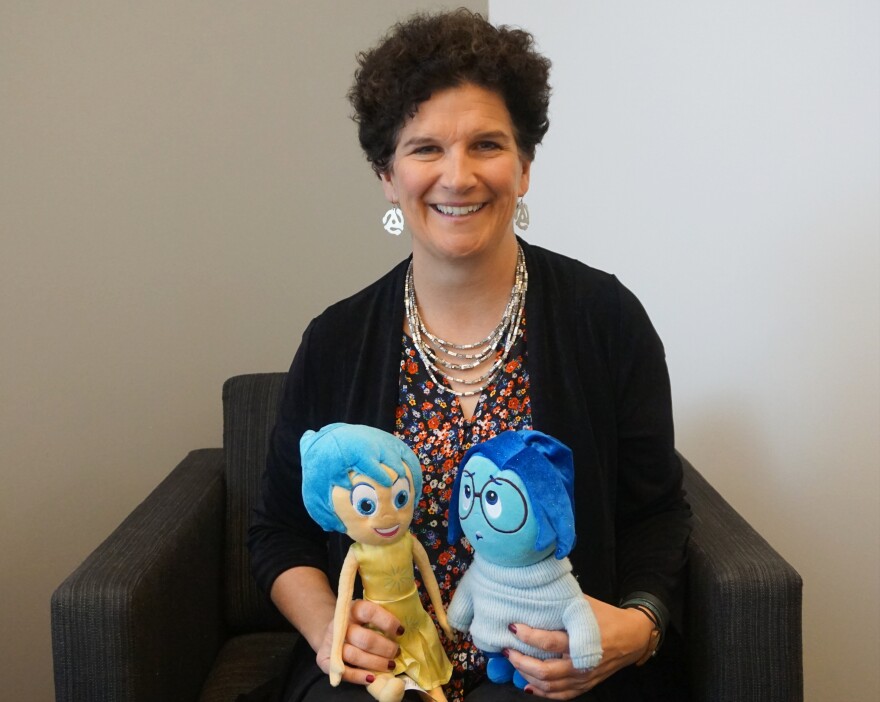 Jill Stratton of Washington University researches the psychology of young adulthood, and part of her mission is to help students be happy and successful. Here, she poses with Joy and Sadness from the 2015 movie "Inside Out."