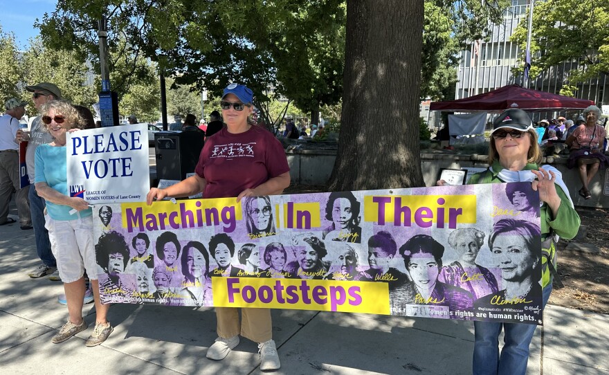 League of Women Voters representatives with banner.