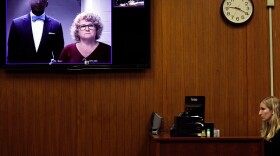 Ex-Michigan State University women's gymnastics coach Kathie Klages appears with her attorney Takura Nyamfukudza at a video arraignment after turning herself in to police in August.