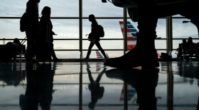 Passengers move through Ronald Reagan National Airport on the day before the Thanksgiving holiday in Arlington, Virginia.
