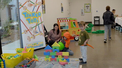 Erica Segal, director of the Central Oregon Children’s Museum, watches as her son Lincoln Segal, 6, tries to knock down a foam tower at the museum’s pop-up event on Oct. 11, 2026 in Bend.