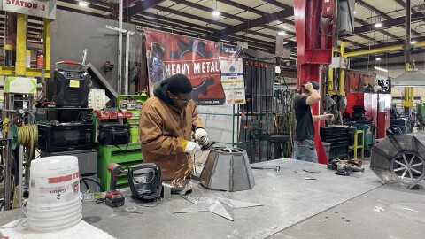 JaShawn Graves uses a grinder to smoothe a weld he just did between pieces of sheet metal at Gunrau Company in Oak Creek. Graves is one of 20 students from across southeastern Wisconsin participating in the weeklong trades-focused summer camp.
