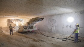 FILE - This undated file image provided by the U.S. Department of Energy shows an electric continuous miner machine run by Randy Wilson, left, and Blas Castaneda, chewing through a wall of salt during the excavation of Panel 8 at the Waste Isolation Pilot Plant near Carlsbad, N.M. On Thursday, Dec. 8, 2022, New Mexico officials outlined new conditions for a proposed permit for the U.S. government to continue disposing of nuclear waste in the southeast corner of the state as part of a multibillion-dollar federal cleanup program. (Samuel Moon Christensen/U.S. Department of Energy via AP, File)