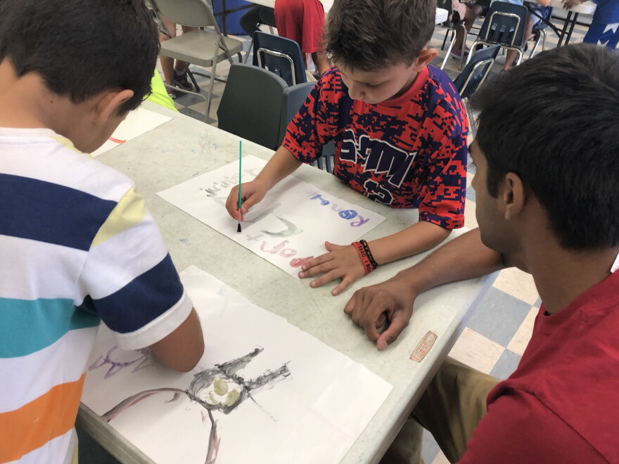 One of Shaunak's campers draws batman. He suggests adding the joker, too. 