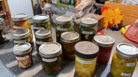 12 jars of assorted homemade quick fridge pickles, sitting on a counter