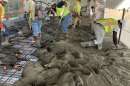 A Truebeck construction crew pours concrete at the future University High School