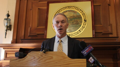New Bedford Mayor Jon Mitchell gives a speech at a podium.