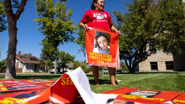FILE - Melissa Lonebear holds a banner with a picture of Kaysera Stops Pretty Places on it during a rally in support of the Missing and Murdered Indigenous People movement at the Big Horn County Building on Aug. 29, 2023, in Hardin, Mont.