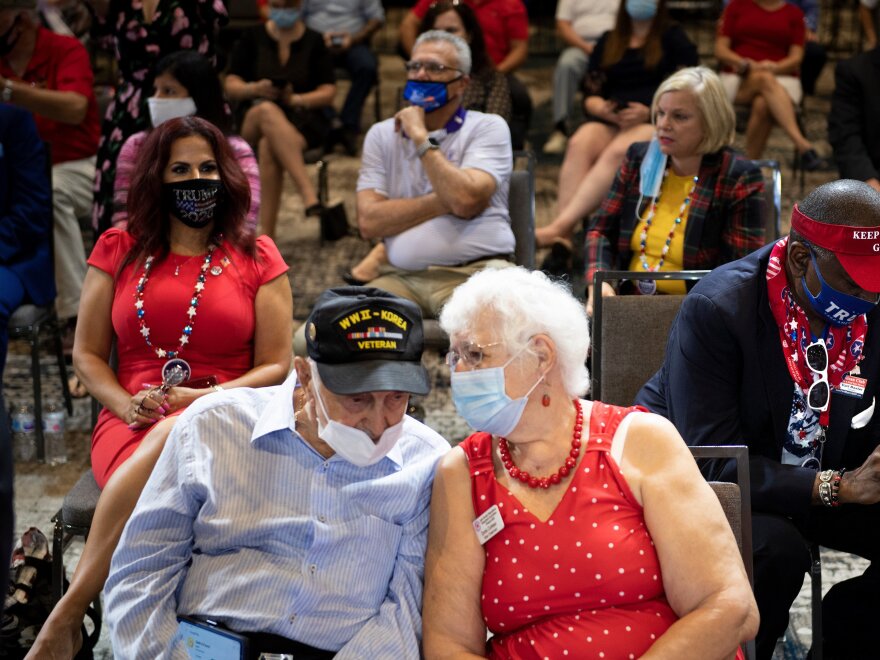 Supporters wait for President Trump to speak on Friday at an event geared toward seniors. A recent survey by seniors' group AARP shows Trump and Joe Biden virtually tied among seniors.