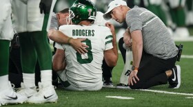 New York Jets quarterback Aaron Rodgers (8) is tended to on the field during the first quarter of an NFL football game against the Buffalo Bills, Monday, Sept. 11, 2023, in East Rutherford, N.J. (AP Photo/Seth Wenig)