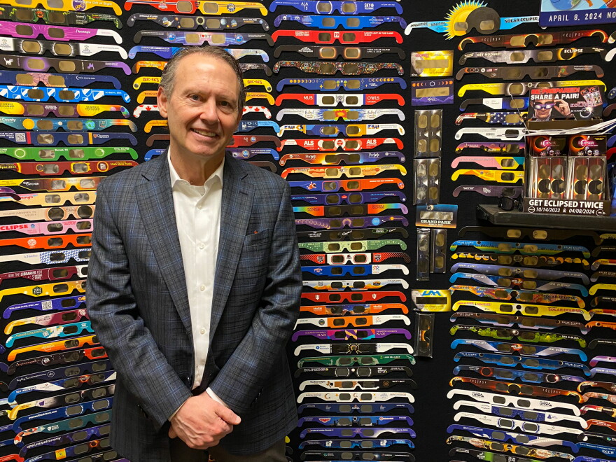 John Jerit, the company's president and founder, stands in front of a selection of custom ordered glasses, the company produced.