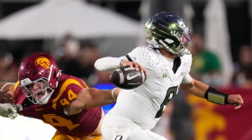 Oregon quarterback Dylan Raiola, right, passes while under pressure from Southern California defensive end Luke Wafle during the second half of an NCAA college football game, Saturday, Sept. 26, 2026, in Los Angeles. (AP Photo/Mark J. Terrill)