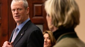 Massachusetts Governor Charlie Baker gestured to Health and Human Services Secretary Marylou Sudders while giving his daily COVID-19 press briefing on Saturday, March 21, 2020.