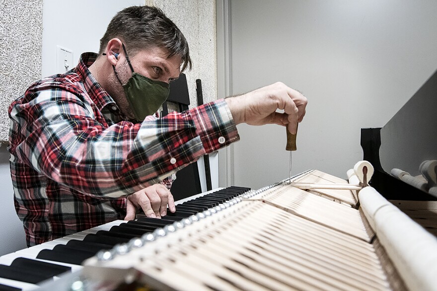 In a small storage room at The Kauffman Center for the Performing Arts, Hulme makes adjustments on a Yamaha concert grand. In normal times, he would have tuned the piano several times a week. When he tuned it in early March, it had been a year since he'd worked on the piano.