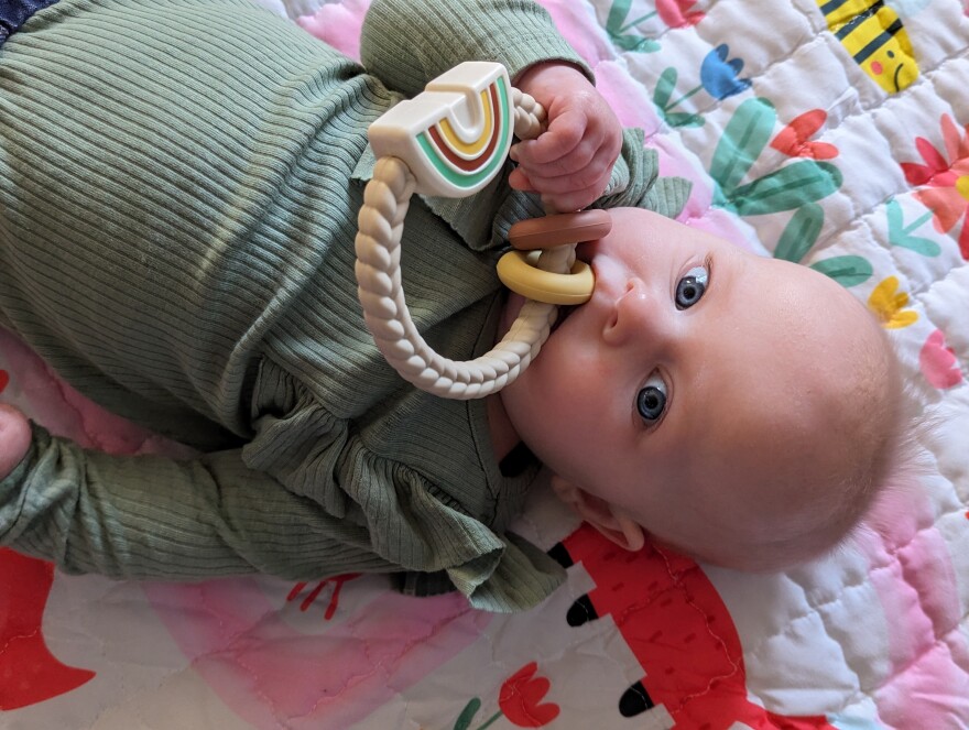 Five-month-old Hailey plays with a rattle at her parents' apartment in Moscow, Idaho. Her parents are taking part in Washington state's new leave program.