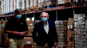Dare to Care executive director Brian Riendeau walks with Senate Majority Leader Mitch McConnell (R-Ky) just before a press conference in Louisville on July 6, 2020.