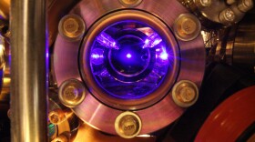Strontium atoms floating in the center of this photo are the heart of the world's most precise clock. The clock is so exact that it can detect tiny shifts in the flow of time itself.