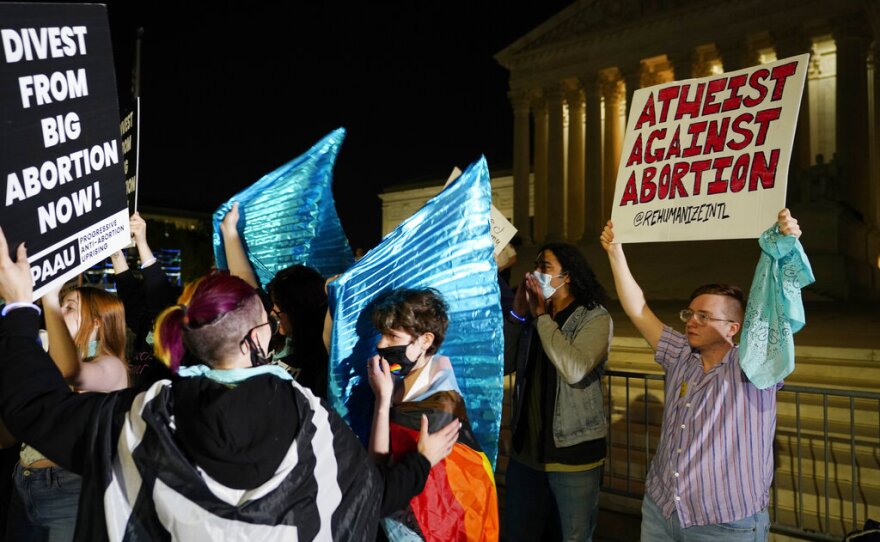 A crowd of anti-abortion protesters gather outside the Supreme Court last night in Washington.