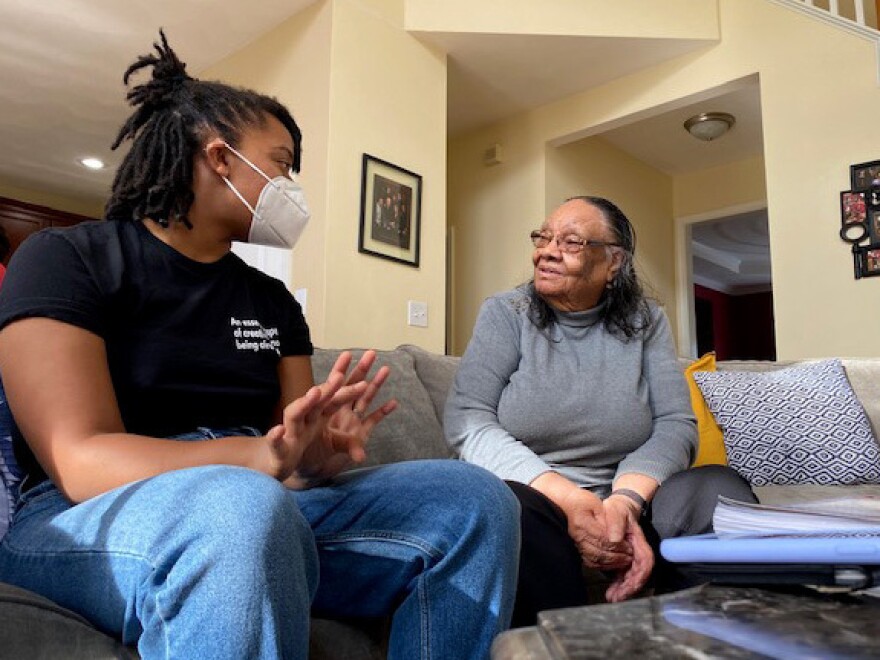 Kandis Wallace Fuller talks with her grandmother, Molly Garris, before a game of spades.