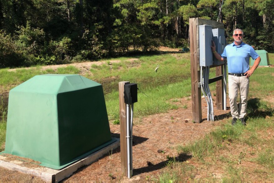 Nags Head Town Engineer David Ryan stands alongside a pump that can lower the water table in a coastal neighborhood. It's part of the town's efforts to better prepare for big storms.