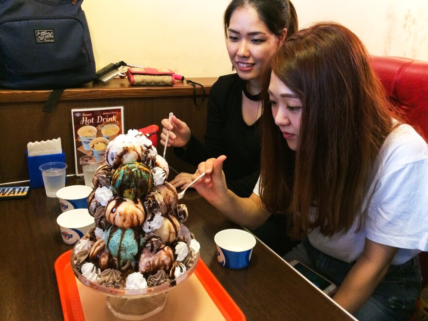 Two Okinawan college students dig into their 17-scoop ice cream treat.