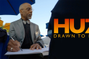 Ron Husband sits at a table to draw.