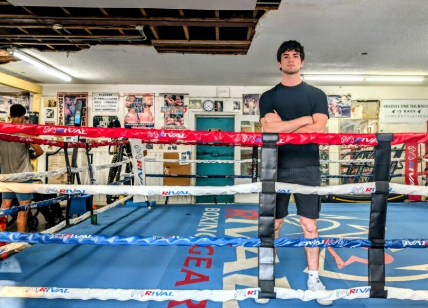 Man stands inside the boxing ring. 