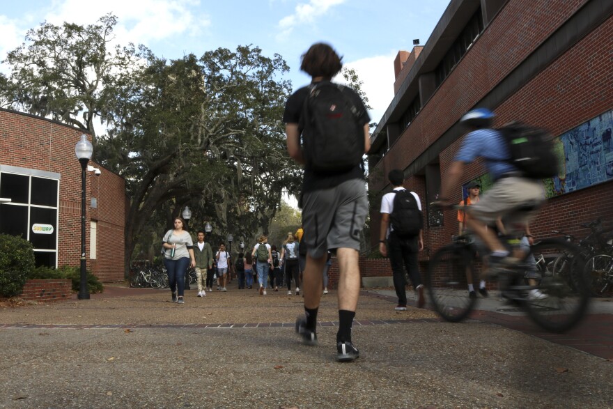 Students walk through Turlington Plaza on the University of Florida Campus in Gainesville, Fla. on Feb. 13, 2020. Out-of-state students who could be considered grandchildren of Florida residents could save thousands of dollars in tuition under a new law.