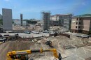View of a construction site with lots of dirt around and cars 