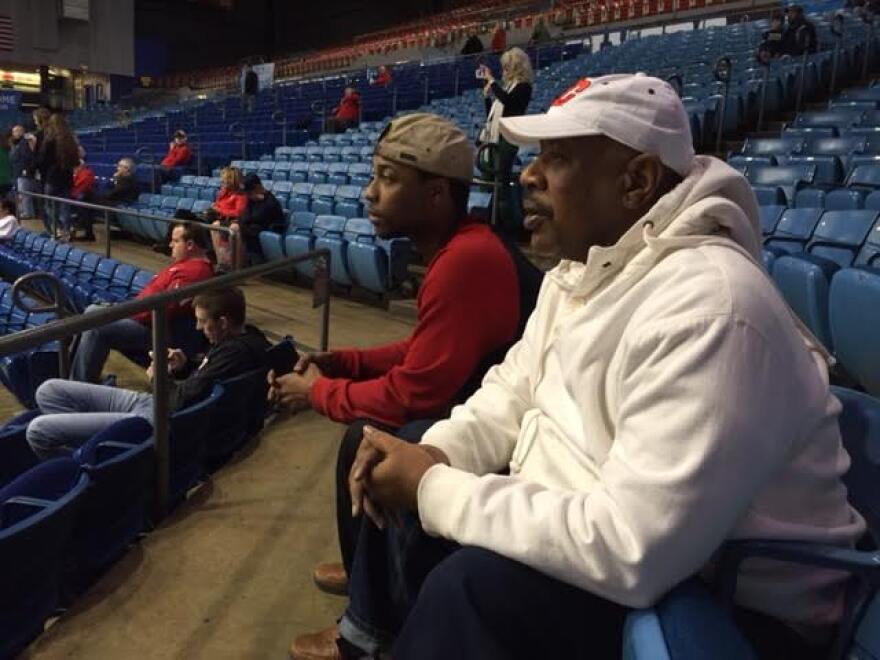 Longtime Flyer fan Steven Easterling of Dayton and his son watch the flyer's first practice in the NCAA tournament