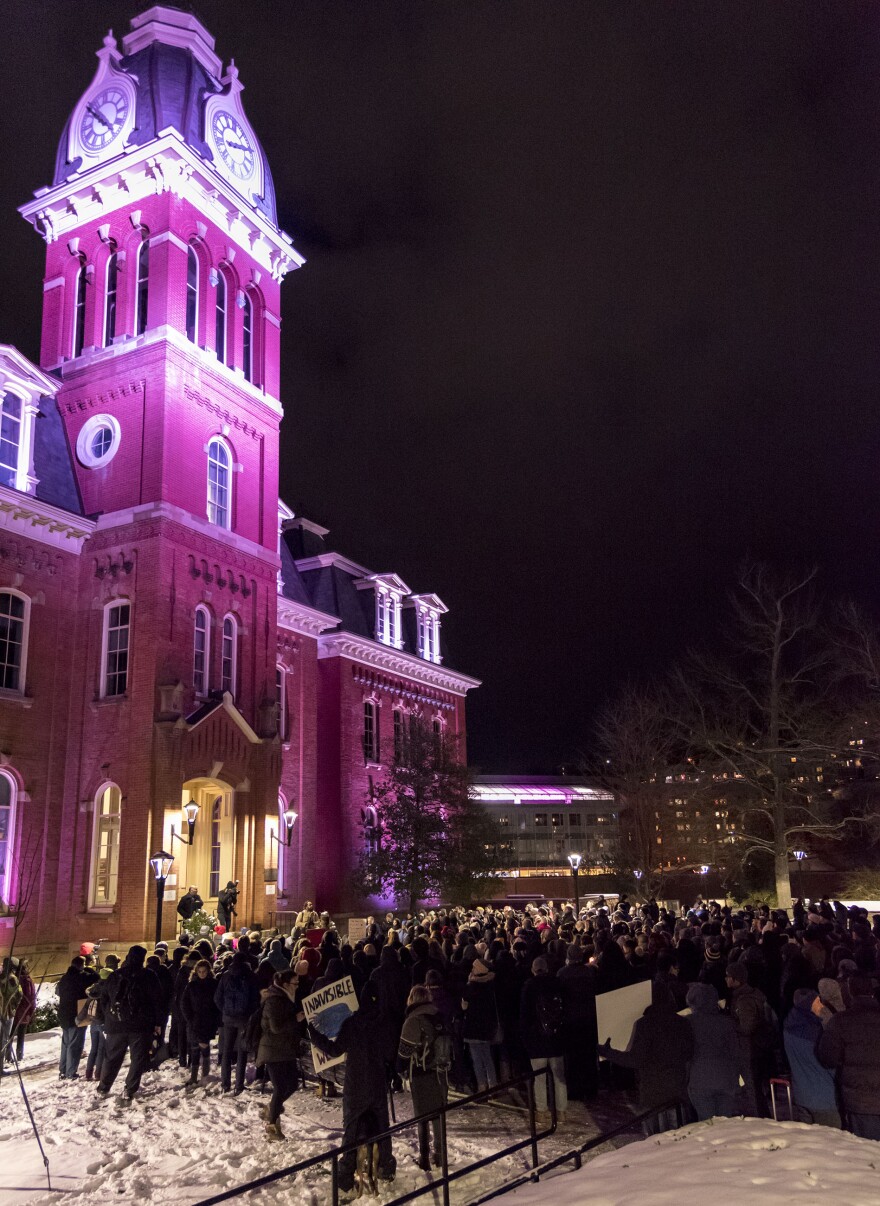 Community members gather at Woodburn Circle for a vigil to support those affected by the executive order.