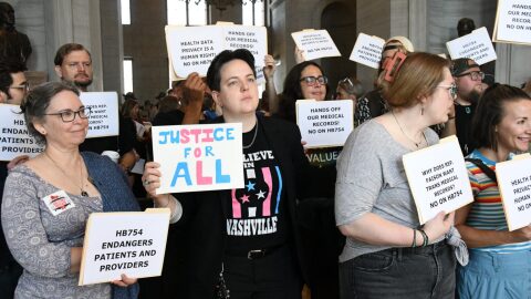 Protestors gather outside the state House as the body votes to approve a measure that would track transgender patients who seek gender-affirming care.