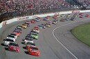 Ricky Rudd, front right, and Jeff Burton, front left, lead the field as they take the green flag to start the NASCAR Cup Series auto race at North Carolina Motor Speedway near Rockingham, N.C., Feb. 21, 1999. 