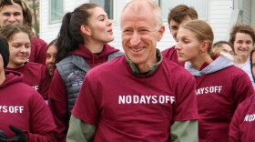 Sandy Hulme (center) wearing his "no days off" t-shirt as part of a celebration at Alma College for his 50-year running streak. Hulme says he's run at least one mile every day since March 5, 1973. (Rick Brewer/WCMU)