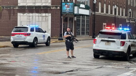 An unidentified officer is armed with an automatic weapon outside Signature School after an apparent false report of someone with a gun inside the downtown school