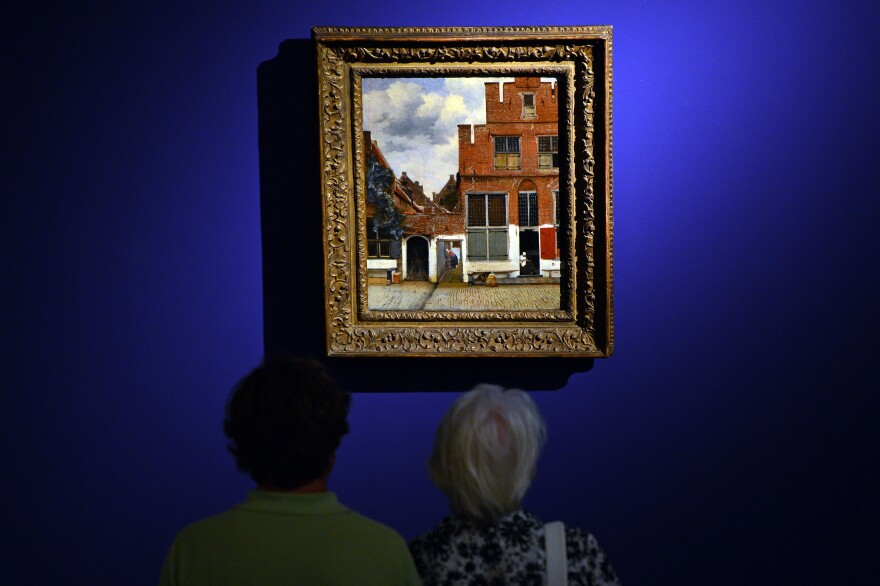 Visitors look at <em>The Little Street</em> by Dutch artist Johannes Vermeer.