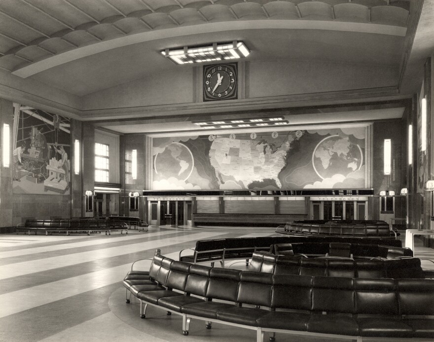 A black and white view of Cincinnati's Union Terminal's concourse, which was torn down in the 1970s. A large map is on the far wall.