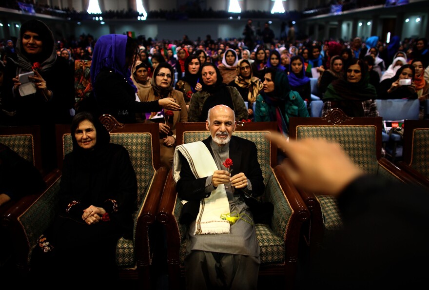 Then-presidential candidate Ashraf Ghani sits next to his wife, Rula, during a campaign rally in Kabul on March 9, 2014. In an unusual move for Afghan politics, Ghani's wife spoke during the rally — a foreshadowing of her role in her husband's presidency.