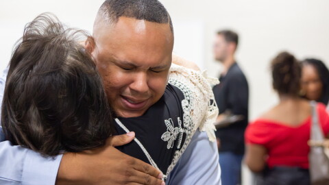 Brock Booker gets a hug from friend Sabrina Shoemaker after his selection to the Wichita Board of Education on Friday.